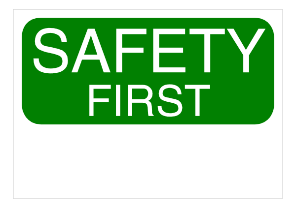 The image shows a green sign with white text that reads "SAFETY FIRST."