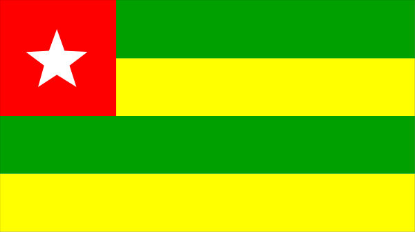 The flag of a country with stars on it flying against a gray background.