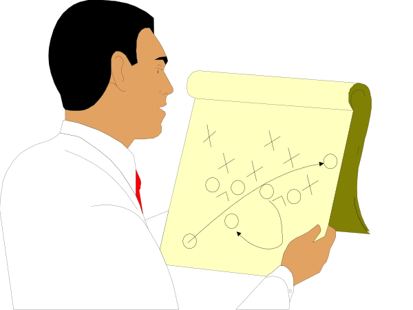 The image shows a person looking at an open book with diagrams on it while standing next to what appears to be a map of some sort in front of them.