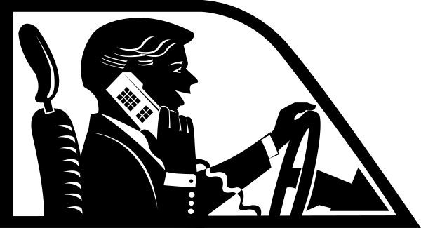 The black and white silhouette of a person sitting at an office desk with their hands on it.