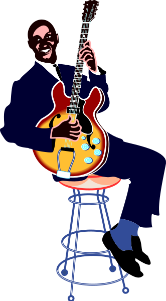 The image shows a person playing an electric guitar on stage with their back to us; there is also a stool visible in front of them.