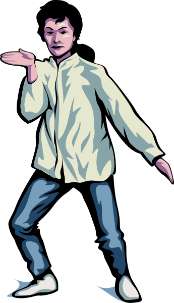 The image shows a man standing with his arms outstretched against a dark background; he is wearing casual clothing including jeans and sneakers.