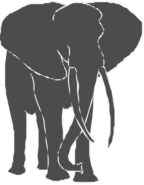 The black silhouette of an elephant with tusks standing next to a smaller baby elephant on what appears to be grassy ground in front of trees under clear skies.