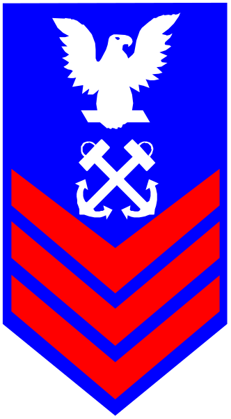 The flag of a naval organization with an eagle emblem on it hanging from a pole.