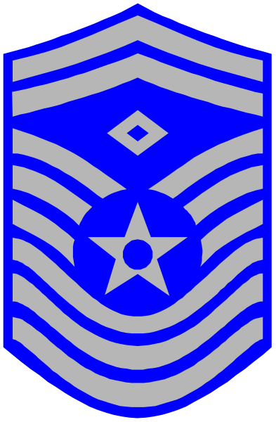 The image shows a blue shield with white stars on it inside an emblem that resembles a military insignia, set against a gray background.