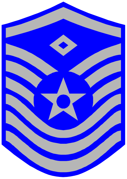 The image shows a stylized emblem with an American flag motif at its center inside of what appears to be a shield shape outlined in blue on white background; there is also a star symbol above it, and below that, another smaller circle containing two stars within each other forming the outline of a hexagon.