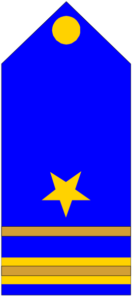 The image shows a blue flag with yellow stars on it hanging from an unseen pole against a gray background.