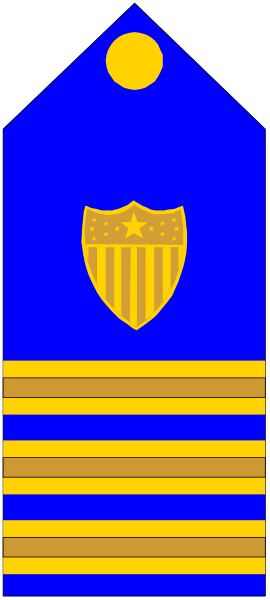 The image shows a blue flag with an emblem of a shield on it inside what appears to be a building structure that resembles a castle tower.