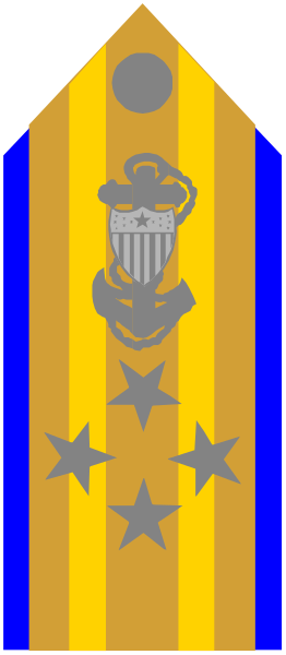 The flag features a blue stripe with stars on it at the bottom right corner of an orange cross symbolizing military service, above which is a white shield containing what appears to be a coat-of-arms design and below that is another emblem resembling a ship's wheel or compass rose.
