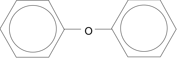 The image shows a dark room with an object that resembles a person standing against a wall on what appears to be a stage set up for some sort of performance or presentation.