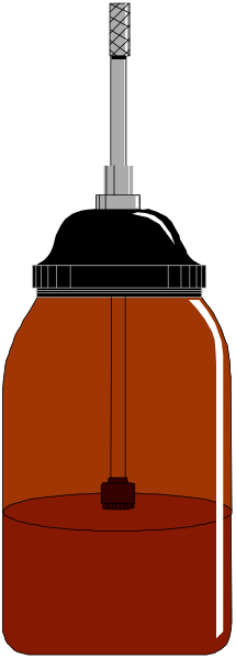 The image shows a bottle of liquid with an orange label placed on top of it against a black background; there is no other object in sight.