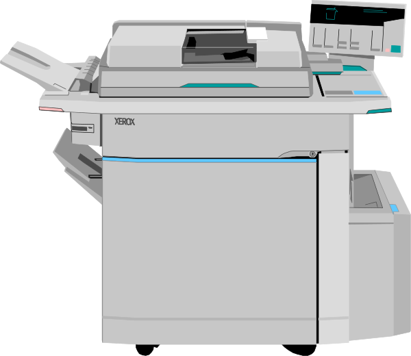 The image shows a printer with paper loaded into it on top of an office desk next to another smaller machine that appears similar but is likely different in function.