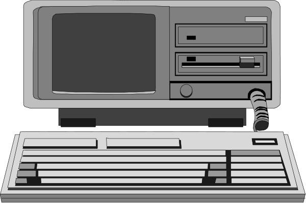 The image shows a computer monitor with an old CRT display next to two keyboards on what appears to be a desk in front of it.