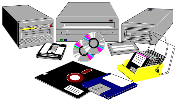 The image shows a collection of computer hardware including two desktop computers with monitors on stands, floppy disks, CDs in cases, cables, an external hard drive, and other miscellaneous items like papers and possibly some office supplies scattered around them all against a dark background.