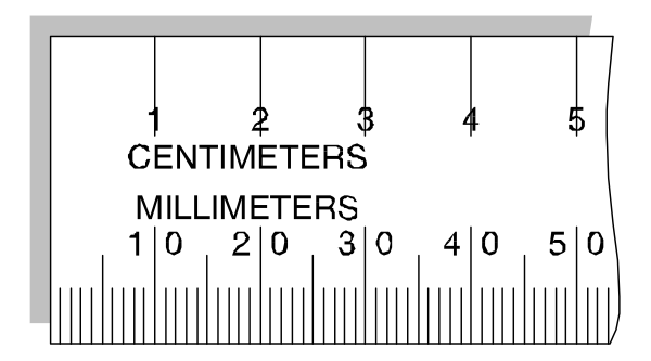 The image shows a ruler with measurements labeled "centimeters" on it, indicating millimeter increments from 0 to 15 centimeters along its length. It is placed against an indistinct background that does not provide any additional context or setting details. There are no objects, people, animals, actions, or other elements present in the image besides the ruler itself and possibly a small portion of what appears to be a surface beneath it.