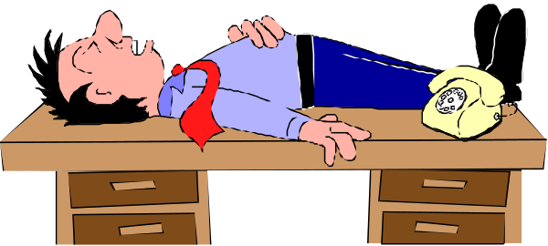 The cartoon depicts a man lying on his back with an old telephone next to him while he is atop a desk in what appears to be a workspace environment.