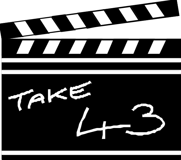 The image shows a black film clapperboard with white text that reads "TAKE 3" on it, indicating this is frame number three of an ongoing take in movie production. There's also some handwritten note saying '4H12', which could be related to the project or scene being filmed. The background appears dark and out-of-focus, emphasizing that attention should focus on the clapperboard itself as it is a key element of filmmaking used for synchronization purposes during post production editing.