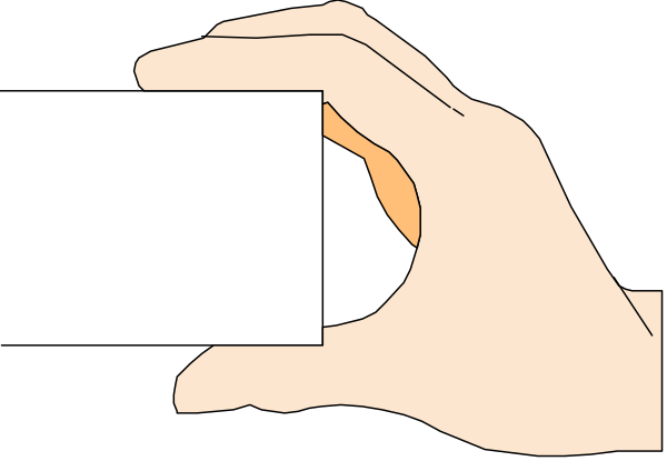The image shows a hand holding an object that resembles food over another similar item on what appears to be paper with text in Japanese characters at the bottom of the frame.