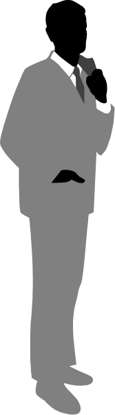 The black and white silhouette of a man standing against a wall with his back to us; he is wearing a suit and tie.