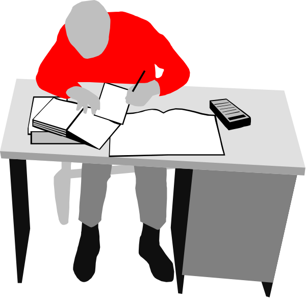 The image shows a person sitting at a desk with an open book on it, writing something down using what appears to be a pen in their hand. There is another individual seated across from them also working on papers. Both individuals seem focused and engaged in some form of study or work activity.
