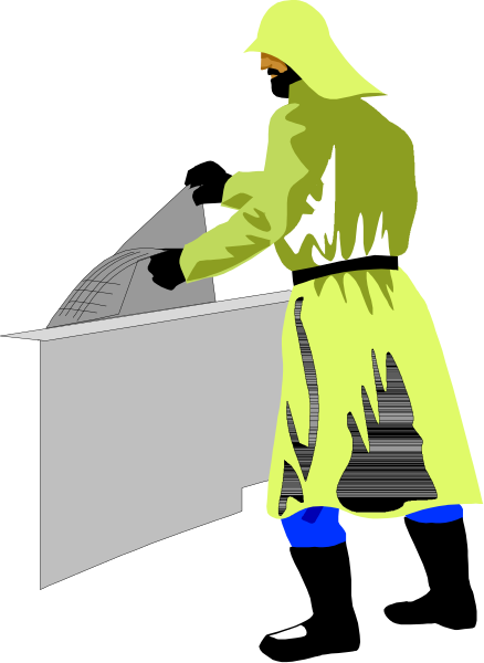 The image shows a person wearing yellow clothing standing next to an object that resembles a map on top of what appears to be a table with papers spread out across it in front of them.