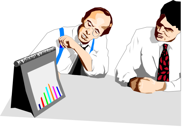 The image shows two men sitting at a desk with an open book of graphs on it; both appear to be engaged in discussion while one man is pointing towards something off-screen.