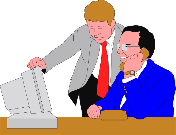 The image shows a man standing behind another seated at an office desk with computer equipment; both appear to be engaged in work-related tasks on computers.