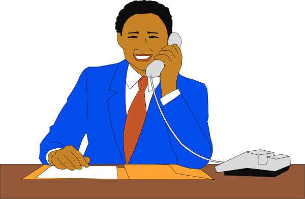 The cartoon depicts a man sitting at an office desk with papers on it; he is talking into a telephone while holding another phone in his hand.