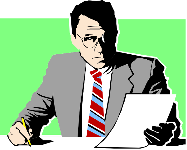 The image shows a man sitting at his desk with papers spread out before him; he is wearing glasses and appears to be reading from one of them while writing on another piece of paper in front of him.