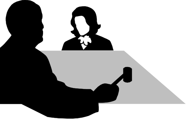 The black and white silhouette of a person sitting at an office desk with their hands on it.