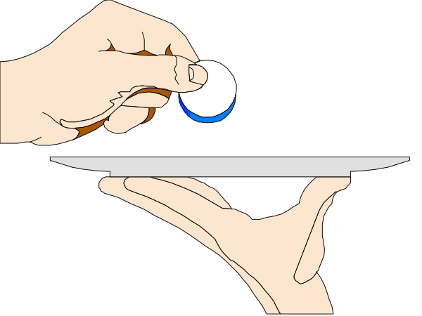 The image shows a hand holding an object over another object with text on it that reads "10%".