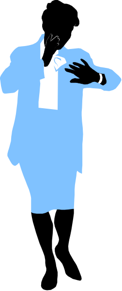The image shows a man standing against a wall with his arms crossed over him; he is wearing sunglasses on top of his head and has short hair.