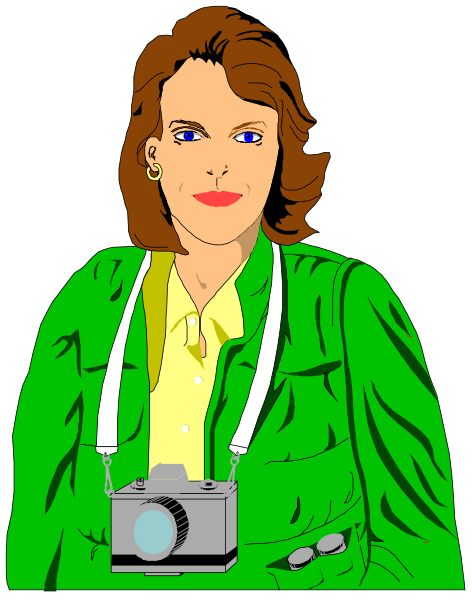 The image shows a woman with blonde hair wearing glasses holding an old camera around her neck while standing against a dark background; she is dressed in green jacket over yellow shirt paired with white pants.