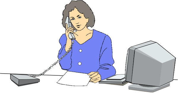 The image shows a woman sitting at an office desk with various items on it including papers, phone, computer monitor, keyboard, mouse, printer, scanner, bookshelf filled with binders, and other miscellaneous objects typically found in an office setting. She is wearing blue clothing and appears to be engaged in work-related tasks or a conversation over the telephone.
