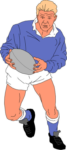 The image shows a man holding a rugby ball while wearing blue shorts with white stripes on them; he is standing against a gray background that has no other discernible features besides him.