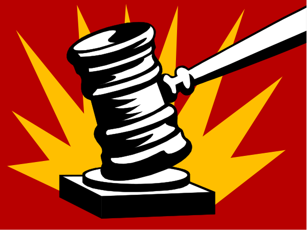 The image shows a cartoon depiction of an object that resembles a gavel with a hammer-like handle on top of it resting against what appears to be a red background featuring some sort of explosion effect, suggesting action or conflict.