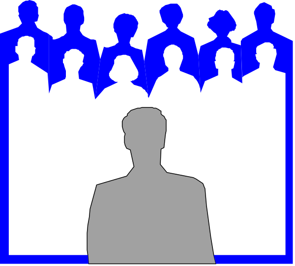 The image shows a black silhouette of an adult male standing on stage with his back to us against a blue background filled with white silhouettes that appear to be spectators in rows facing towards him from both sides, suggesting he is giving a speech at some sort of event or gathering where people are seated and attentive.