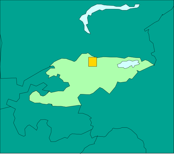 The map shows a region with various territories outlined by different shades of green; there is an area highlighted in yellow near what appears to be water on one side, possibly indicating some sort of focus or importance for that particular territory within this context.
