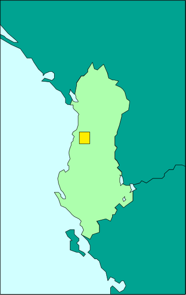 The image shows a map with an overlaid photo of a person standing on top of it at nighttime.