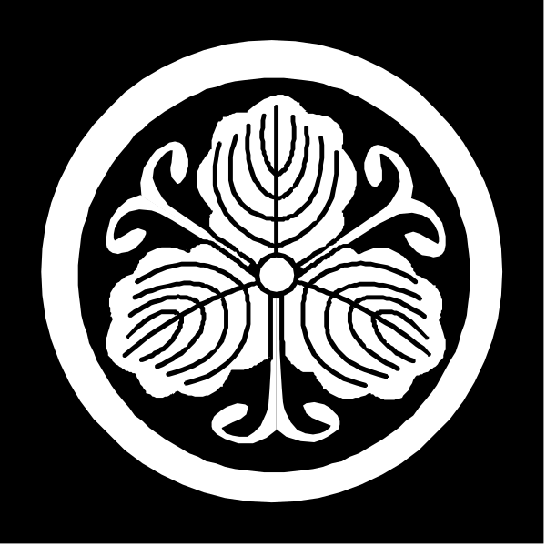 The image shows a black and white emblem with an intricate design featuring what appears to be Japanese characters within it, surrounded by decorative elements that resemble leaves on either side of a central motif which could represent a flower or blossom-like shape.