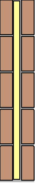 The image shows a tall brick structure with yellow bricks on top of it against an indistinct background.