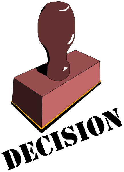 The image shows a red brick with an abstract sculpture on top of it against a black background.