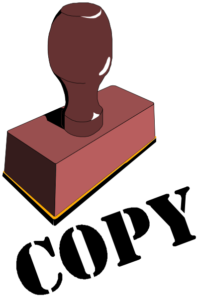 The image shows a red block with an illustration of a wooden handle on top placed over another rectangular object that appears to be made from wood as well.