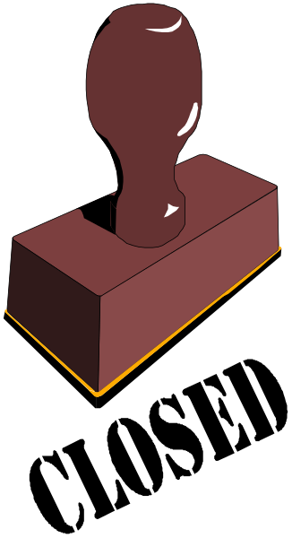 The image shows a red brick on top of another object with an orange base that has two holes cut into it; there is also what appears to be a small figure in front of this setup.