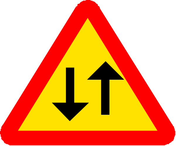 The image shows a red traffic sign with white arrows indicating directions to different lanes on an unseen roadway.