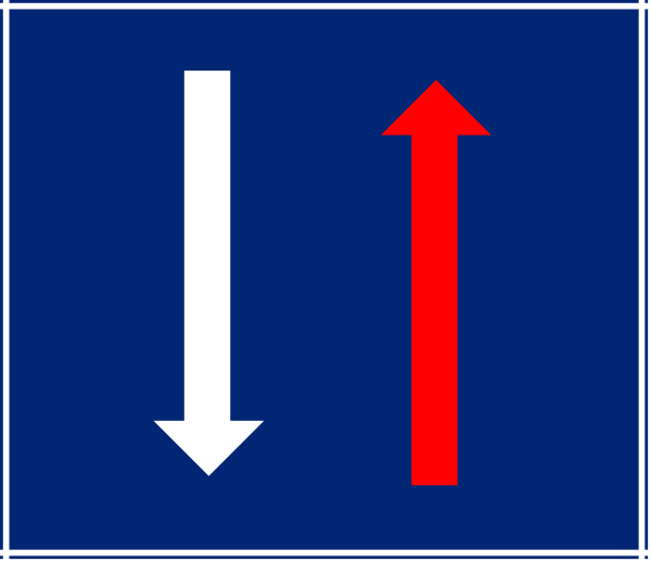 The image shows a blue sign with an arrow pointing downward to indicate directional movement towards something below it on the right side of the frame.