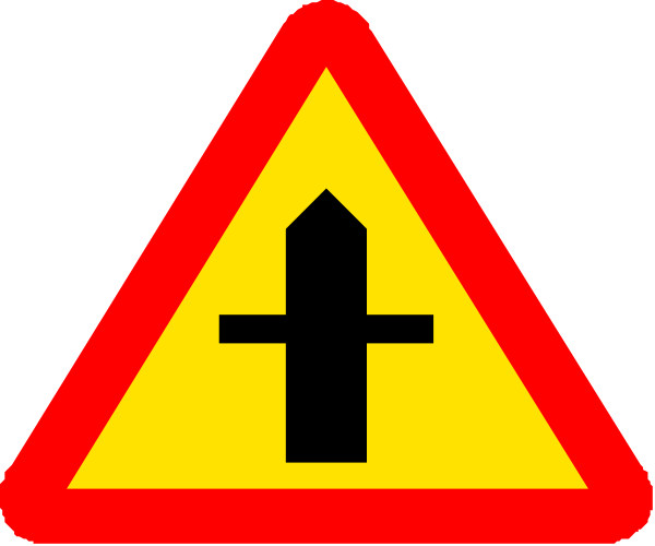 The image shows a red sign with an arrow pointing upwards on top of another yellow triangular road sign that has two white crosses inside it.
