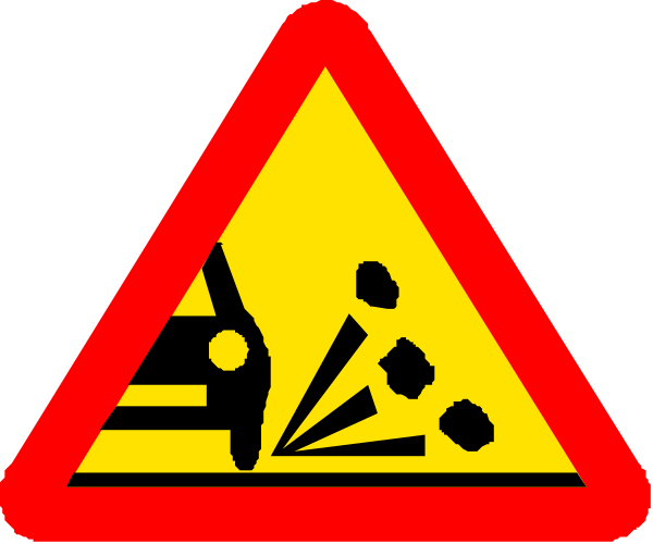 The image shows a red triangular warning sign with black symbols indicating construction work ahead on an overcast day.