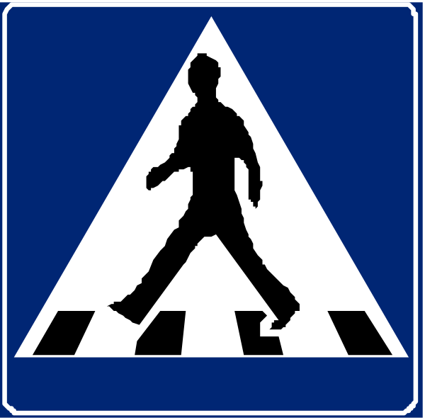 The image shows a blue pedestrian crossing sign with white text on it that reads "Zebra Crossing" at both ends of an arrow pointing to each other in front of two people walking across what appears to be a crosswalk, indicating safe passage for pedestrians and cyclists alike.