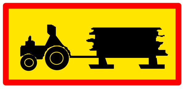 The image shows a red sign with white text that reads "STOP" at its top left corner; below this is an illustration of two stacked wooden crates on wheels being pulled by what appears to be a tractor, and there's also another smaller crate in front of the larger one.